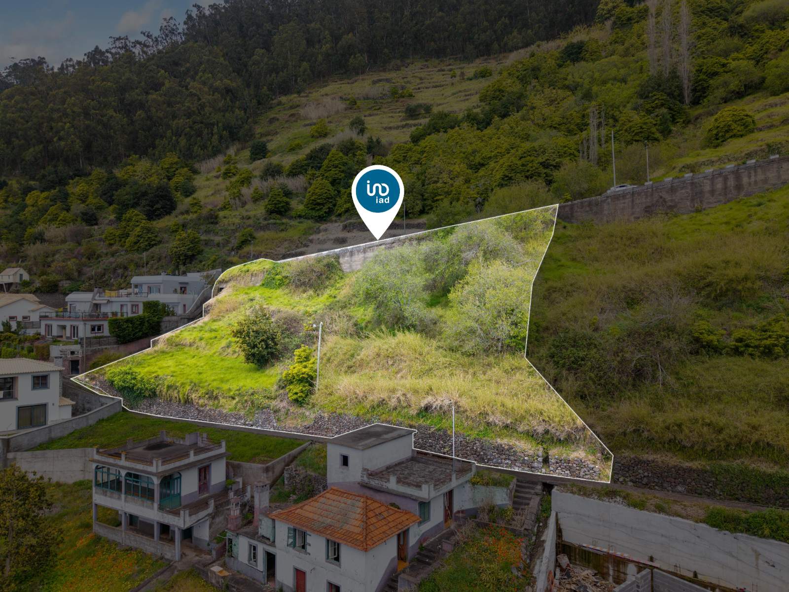 Aerial view of the plot boundary outlined in white, marked by the listing agency's location pin