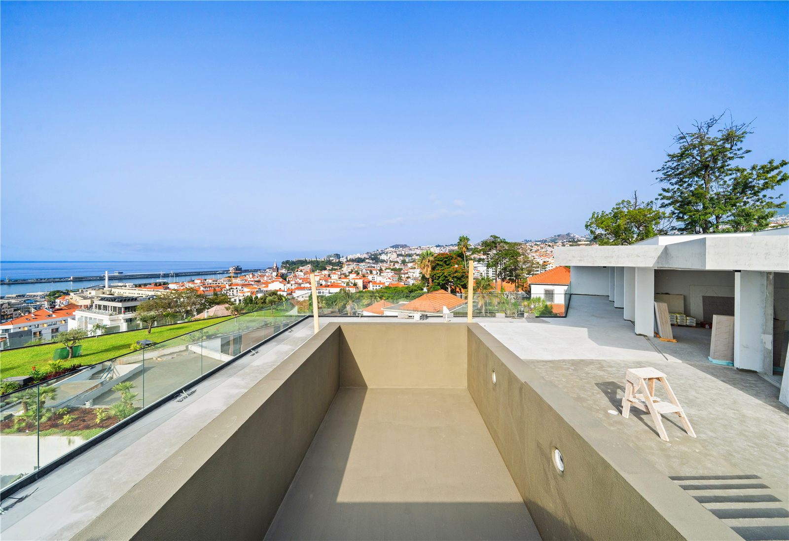 The penthouse roof terrace under construction, the swimming pool still an empty concrete shell, Funchal and the sea beyond