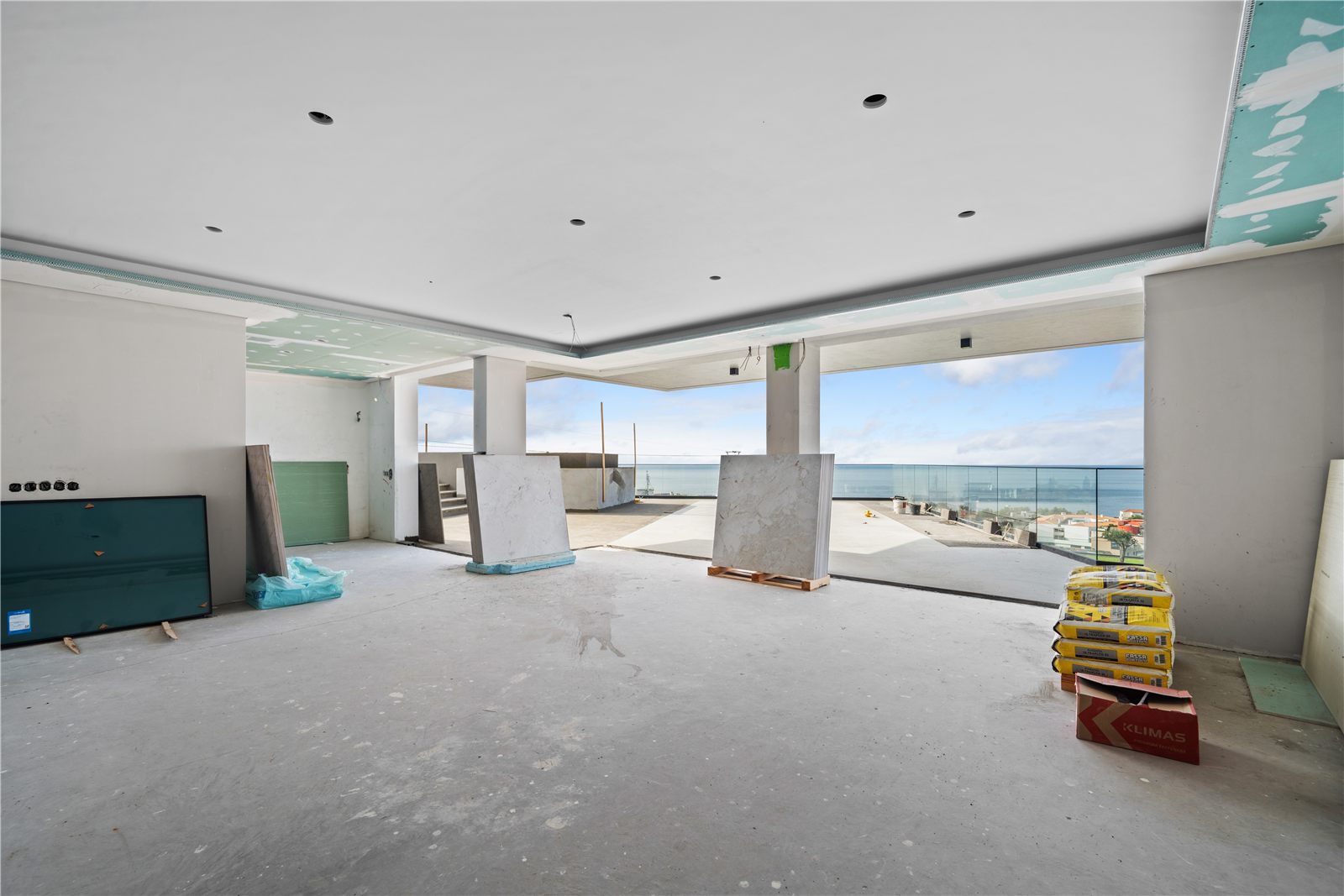 The same living space from the opposite end, glazing panels and packaging still on the floor