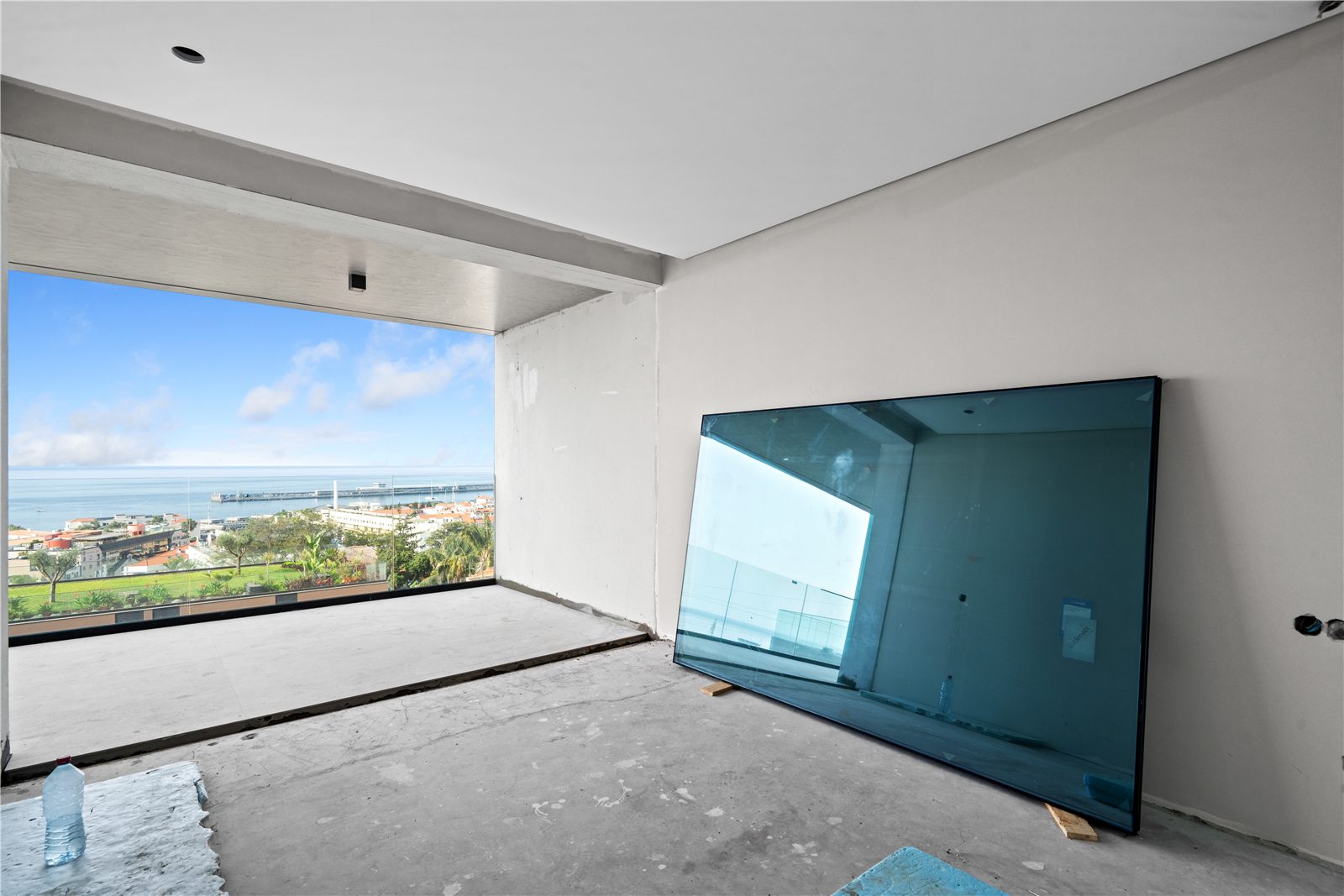 A second room with the same full-width view, a glazing panel waiting to be installed