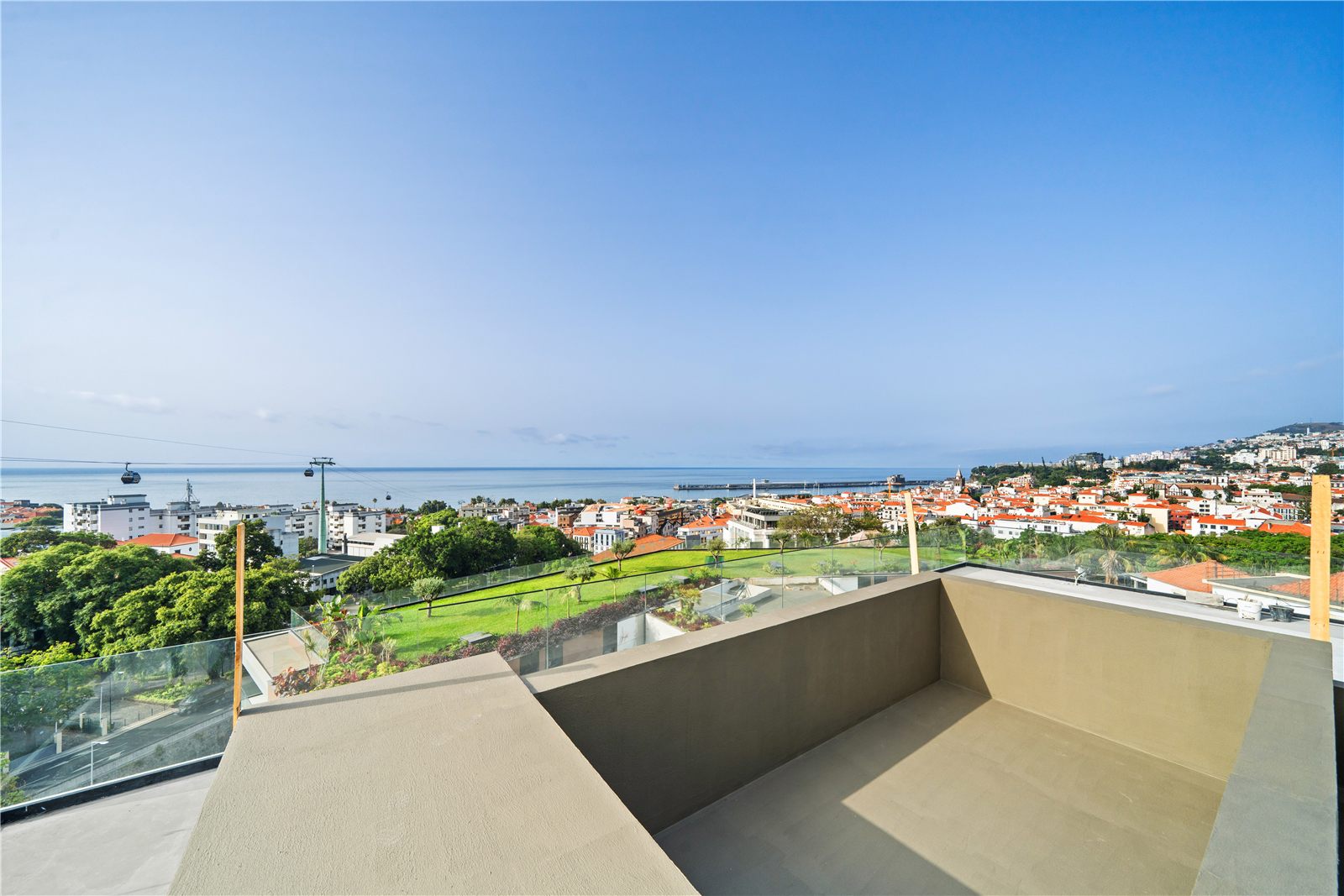 The terrace and the empty pool shell with Funchal spread out behind