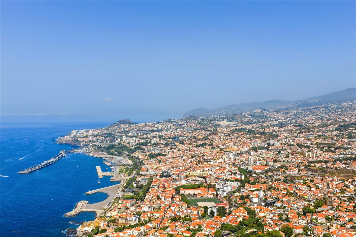 Aerial view along the Funchal waterfront with the marina and the city behind