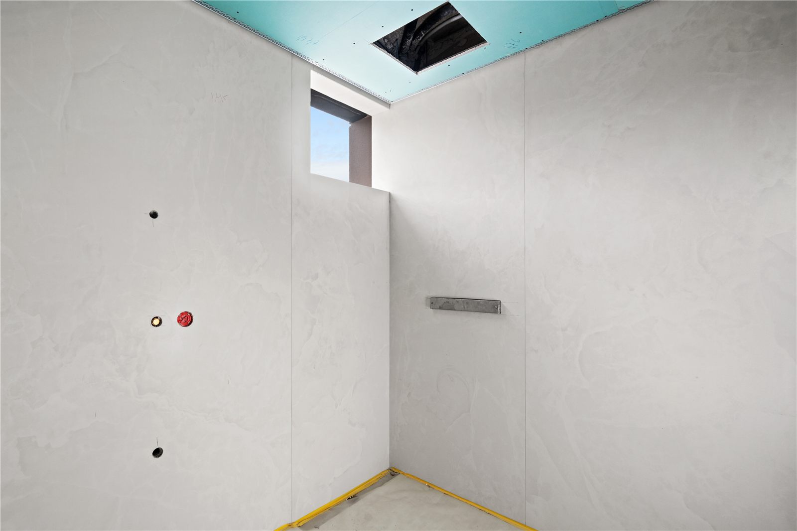 A second unfinished room in plaster and bare concrete