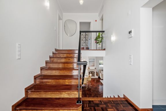 Dark timber staircase rising from the hallway
